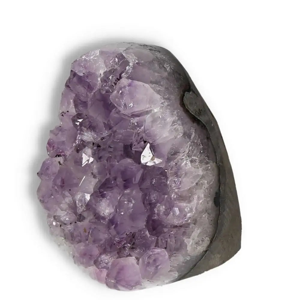 Amethyst cut base geode from Sylvia Crystals, featuring rich purple hues and natural crystalline formations for spiritual elegance.