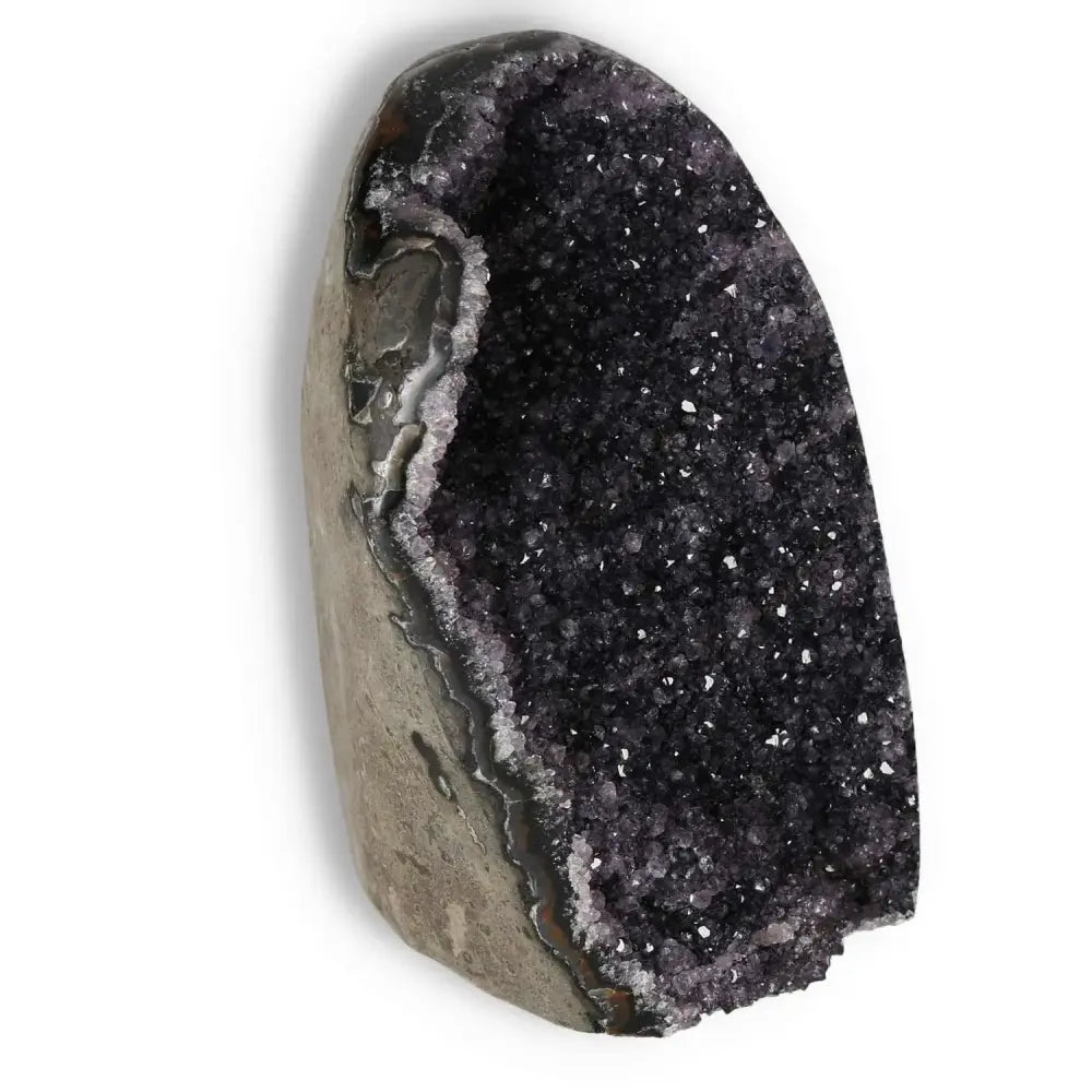 Amethyst cut base geode with deep purple hues, from Sylvia Crystals, showcasing spiritual elegance and natural beauty.