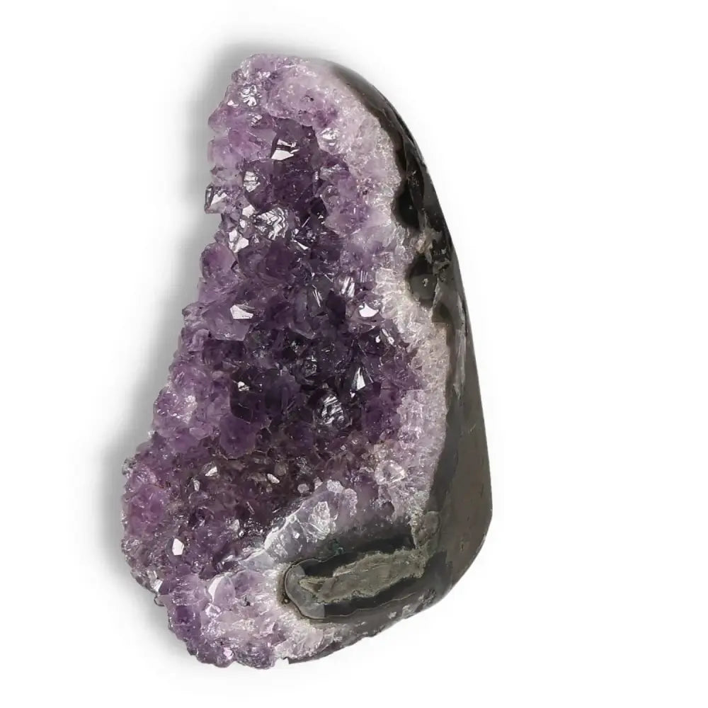 Amethyst cut base geode from Sylvia Crystals showcasing vibrant purple hues, perfect for stress relief and enhancing concentration.