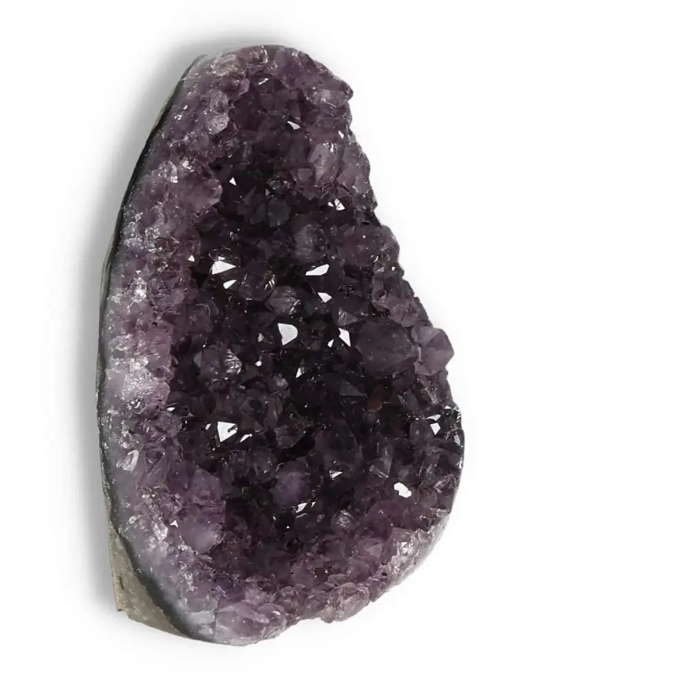 Amethyst cut base geode from Sylvia Crystals, showcasing deep purple hues and premium craftsmanship for tranquility and luxury.