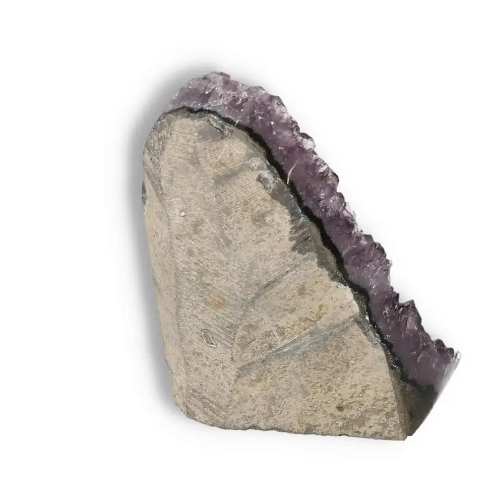 Amethyst cut base geode displaying deep purple hues and natural formations, embodying luxury and tranquility from Sylvia Crystals.