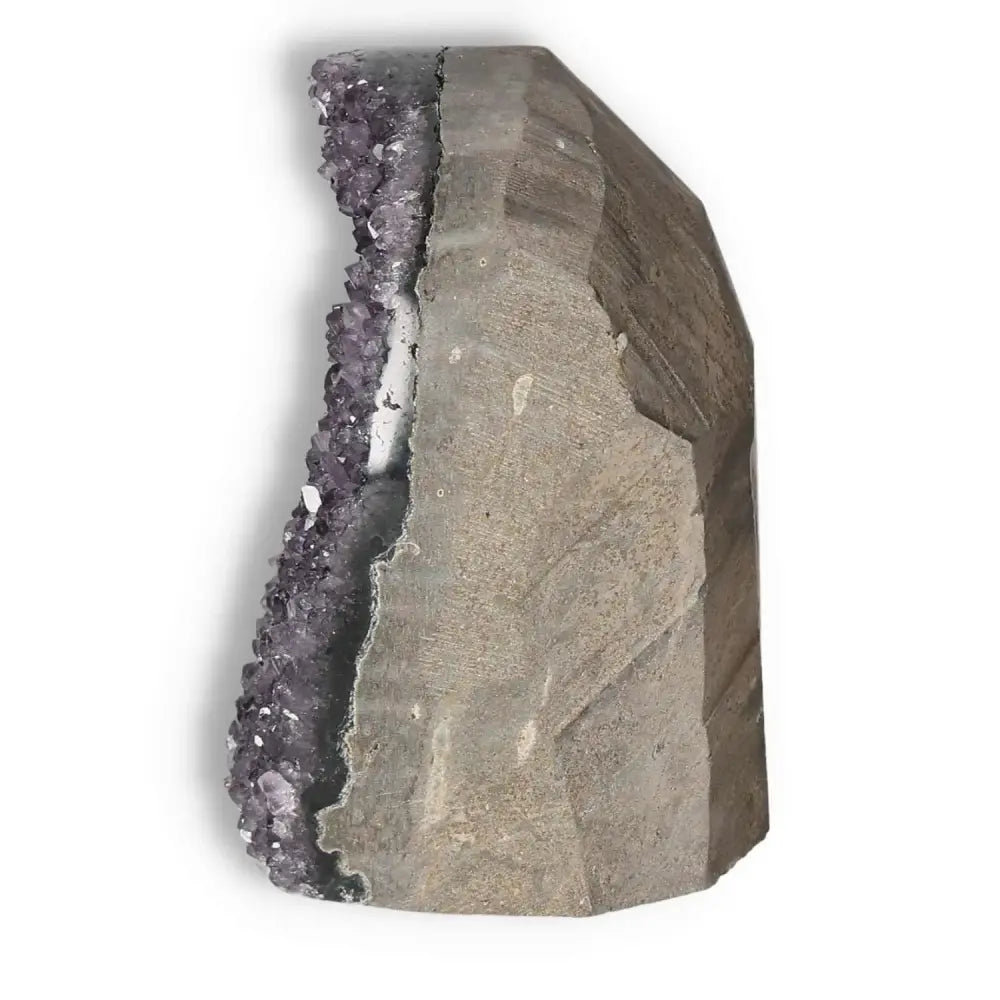 Amethyst cut base geode from Sylvia Crystals, showcasing its purple crystal formation on a natural stone base, known for stress relief and energy boost.