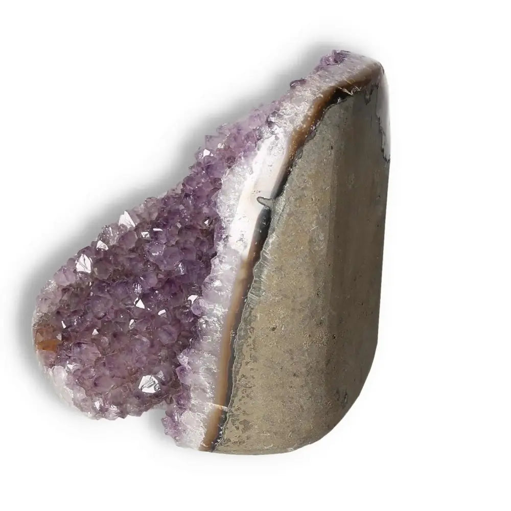 Amethyst cut base geode displaying purple crystal formations, known for stress alleviation and transformative energy.