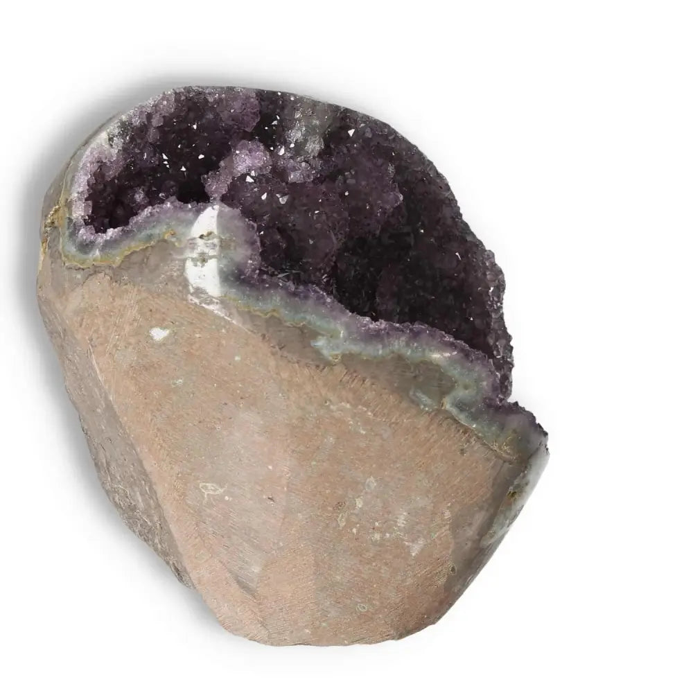 Amethyst cut base geode with rich purple hues, offered by Sylvia Crystals, showcasing natural formation and crystalline structure.