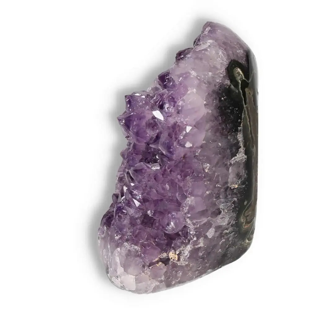 Amethyst cut base geode by Sylvia Crystals, showcasing its stunning purple crystals and natural beauty. Ideal for stress relief and energy balance.