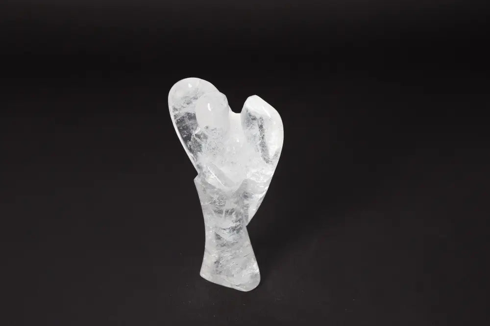 Clear angel-shaped Lemurian Quartz sculpture displayed on a dark background, 13 cm tall. Enhances concentration and emotional stability.