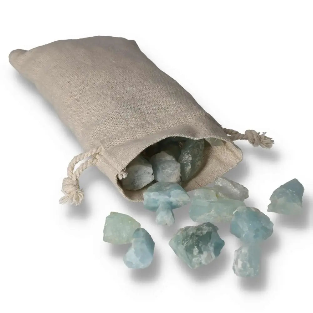 Aquamarine druze crystals spilling from burlap pouch, showcasing their soothing blue hues and natural sparkle, perfect for energy work.
