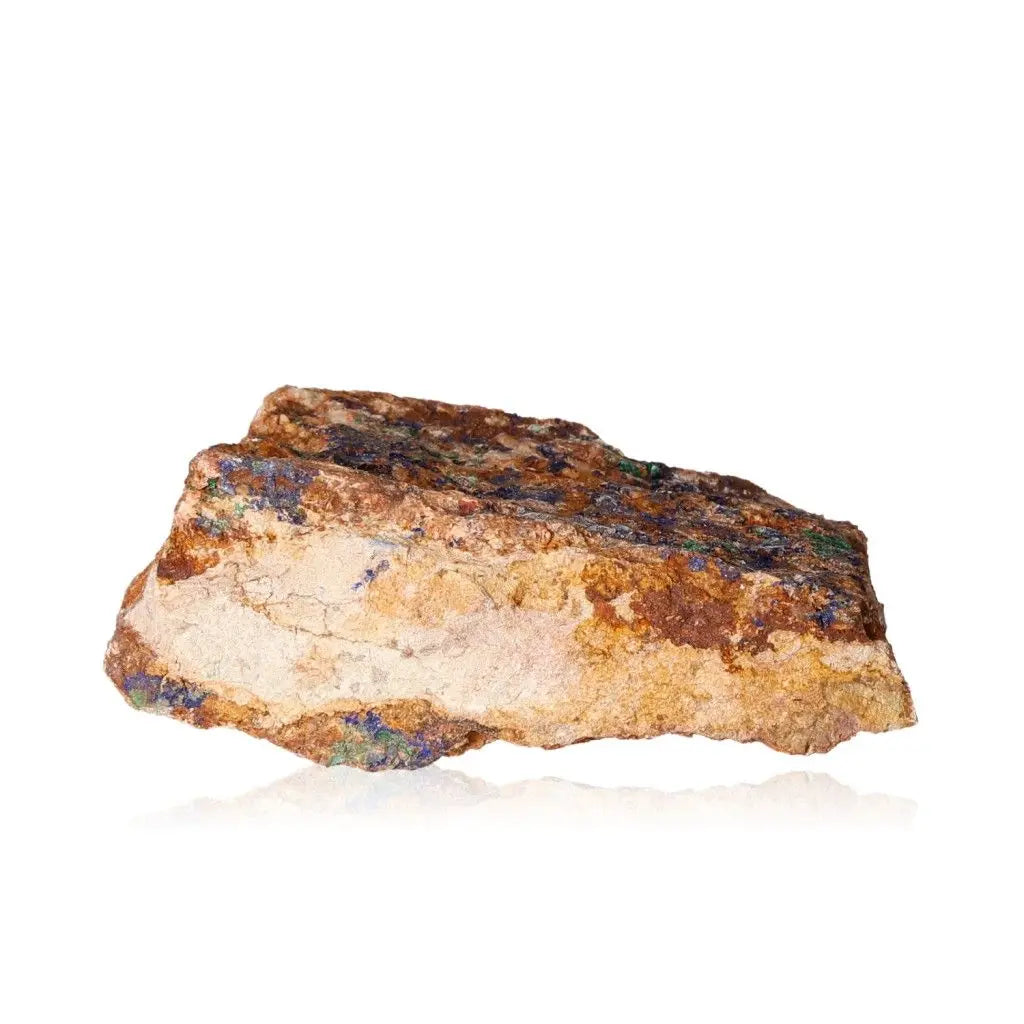 Raw Azurite stone with deep blue hues and unique patterns against a white background, showcasing its copper composition and natural beauty.