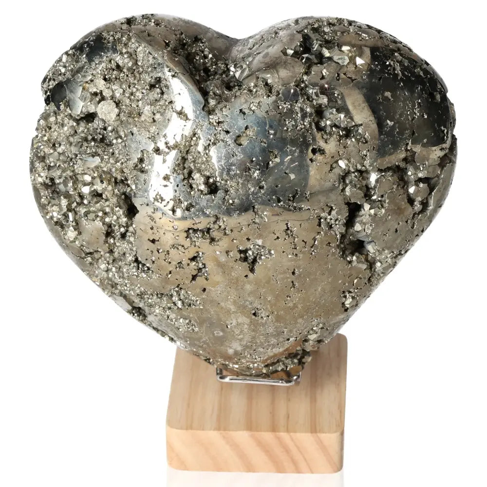 Big pyrite heart-shaped stone on a wooden stand, symbolizing courage and initiative, supports mental and material independence.
