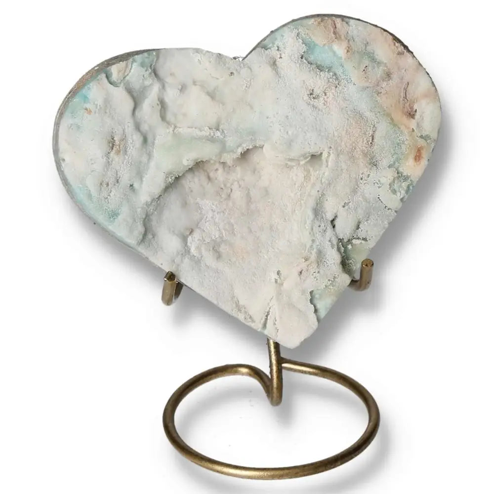 Heart-shaped Blue Aragonite gemstone on a stand, showcasing unique ocean-blue hues for tranquility and emotional healing.