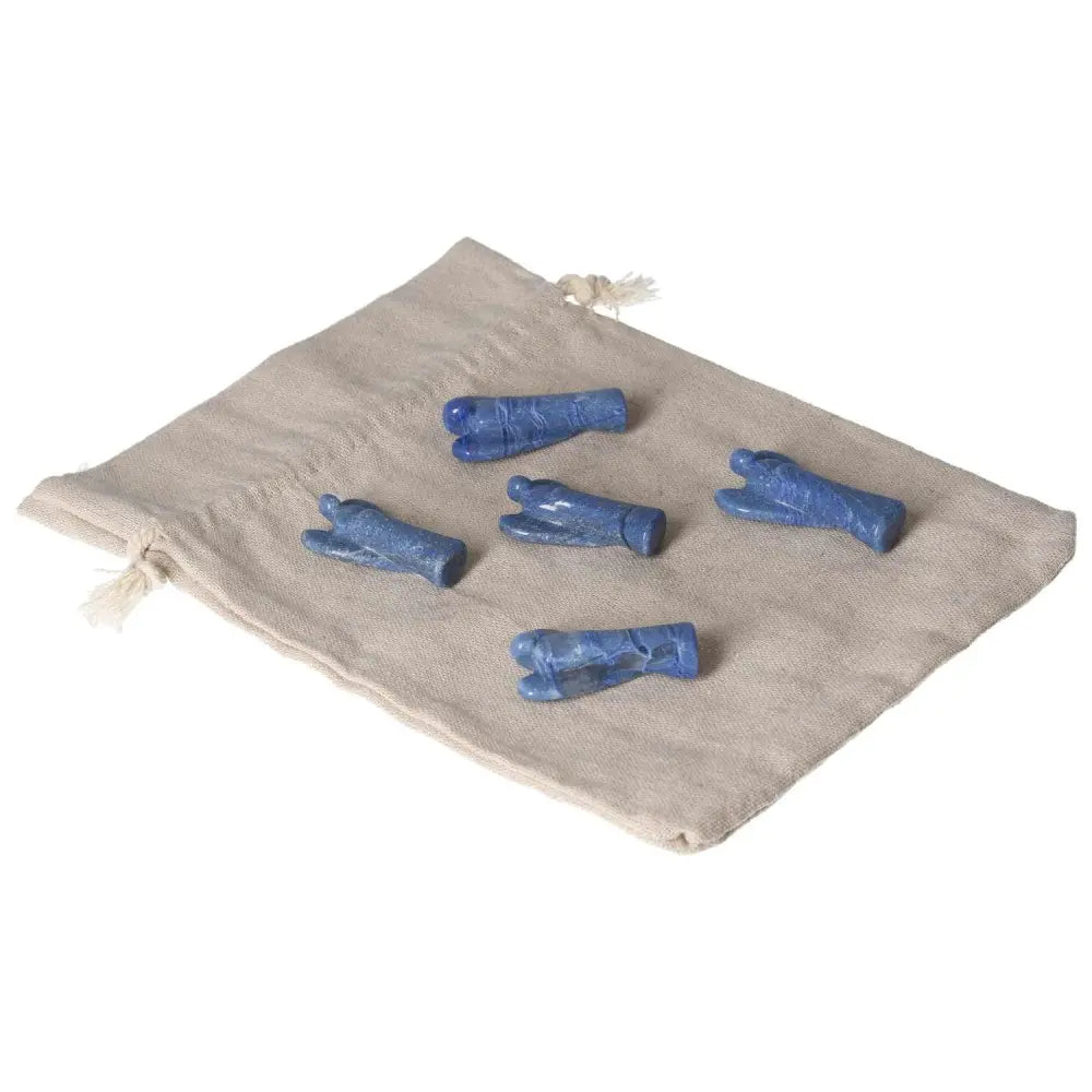 Small Blue Aventurine angels on a beige cloth, symbolizing inner peace, intuition, and gentle strength.