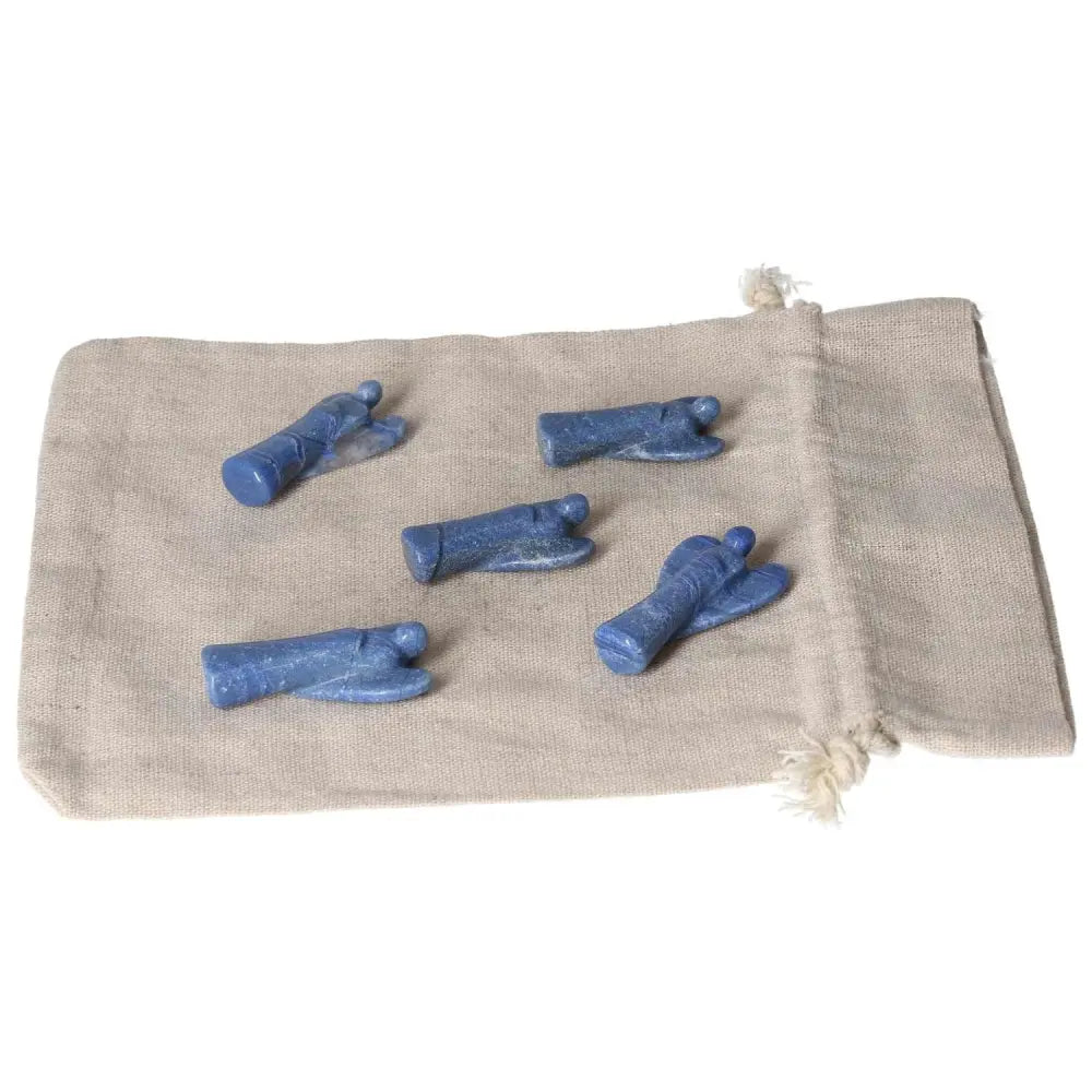 Five small Blue Aventurine angels on a beige cloth, symbolizing calm, intuition, and gentle strength.