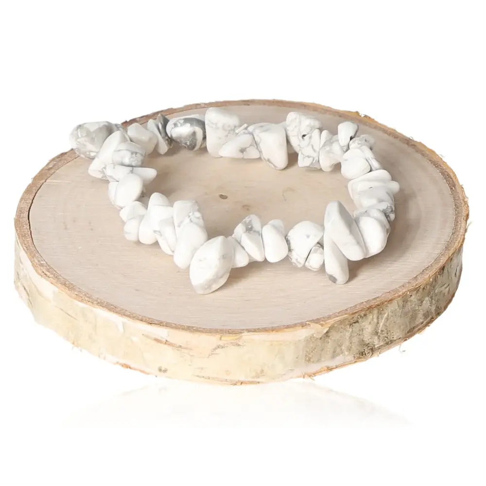 Bracelet made with genuine magnesite chips displayed on a natural wooden base, showcasing earthy elegance and serene beauty.