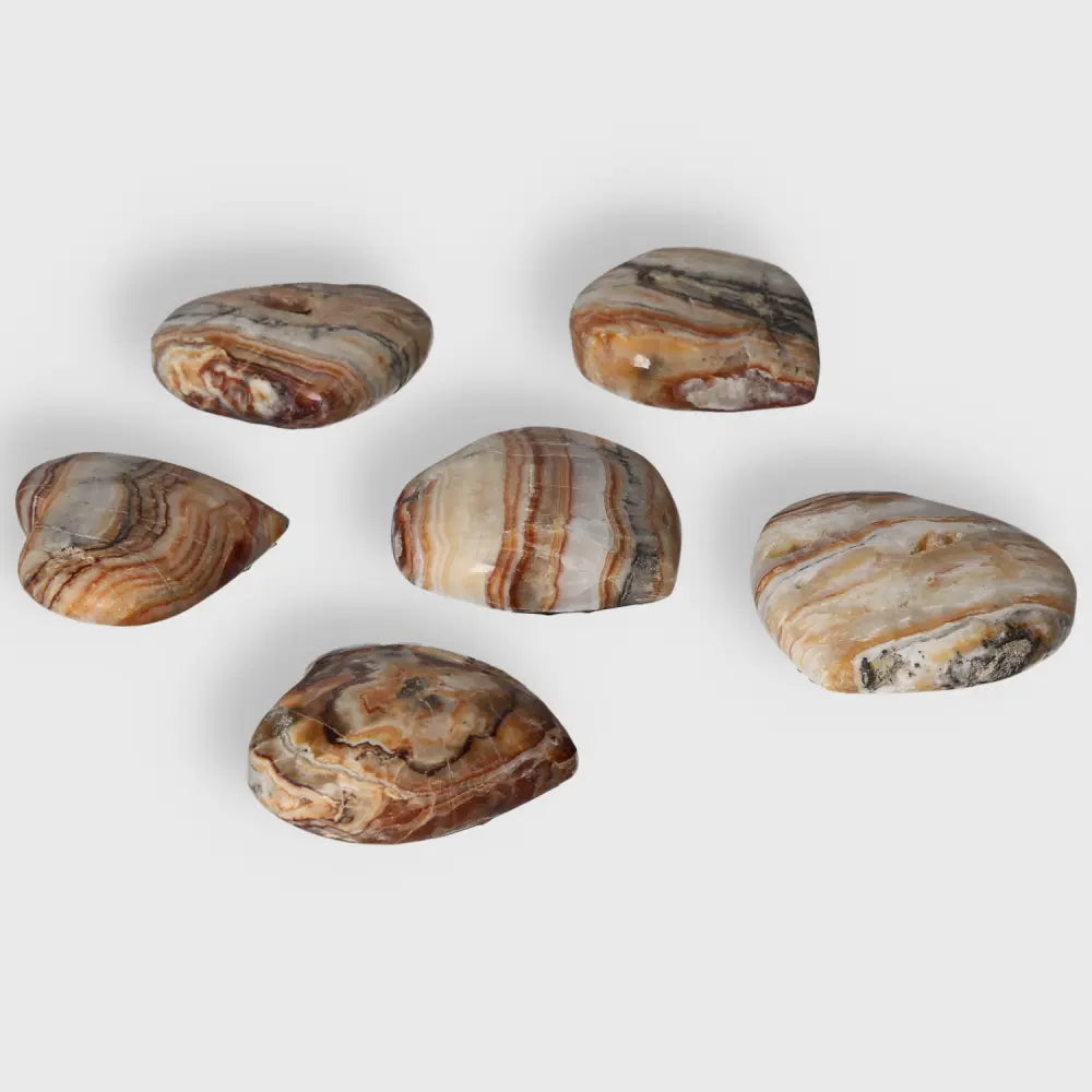 Brown Aragonite Heart gemstones showcasing earthy tones and intricate patterns, promoting stability and emotional healing.