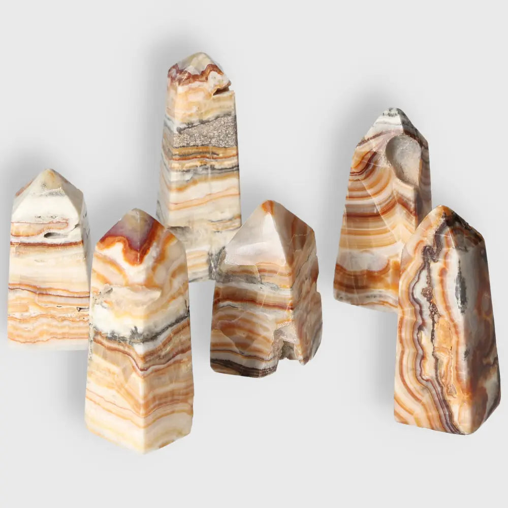 Collection of natural brown aragonite crystal towers showcasing earthy tones with powerful grounding and stabilizing energies