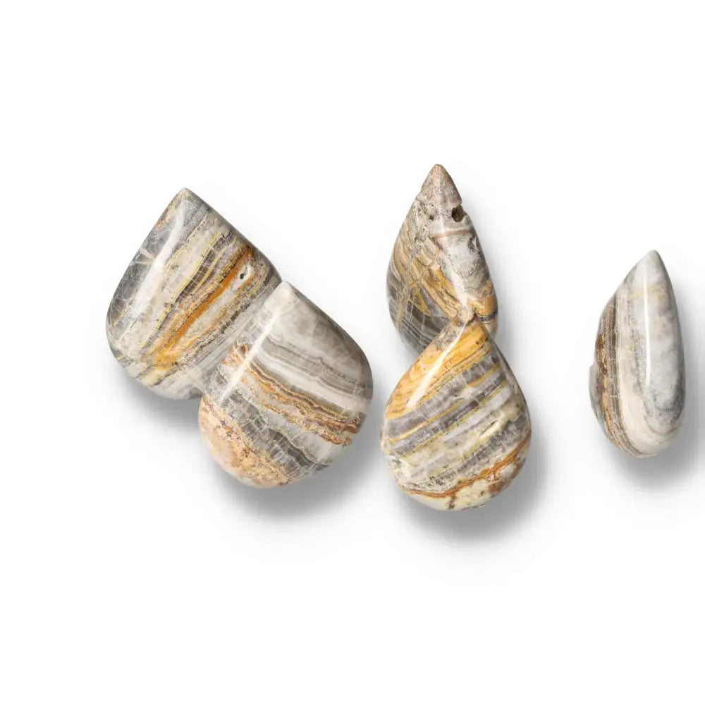 Bumblebee Onyx stones showcasing bold yellow, black, and white bands, symbolizing strength and balance in a captivating pattern.