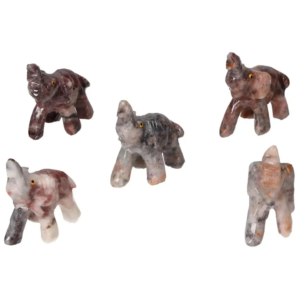 Five carved crystal elephants handcrafted from high-quality magnesite, showcasing unique variations and spiritual elegance.