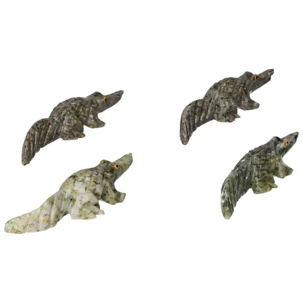 Carved dolomite alligator figurines from Sylvia Crystals displaying intricate craftsmanship and luxury design.