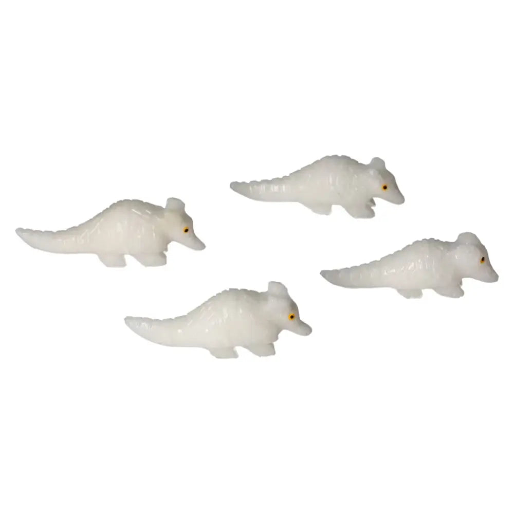 Four carved dolomite armadillo figures showcasing smooth white finish, symbolizing serenity and craftsmanship.