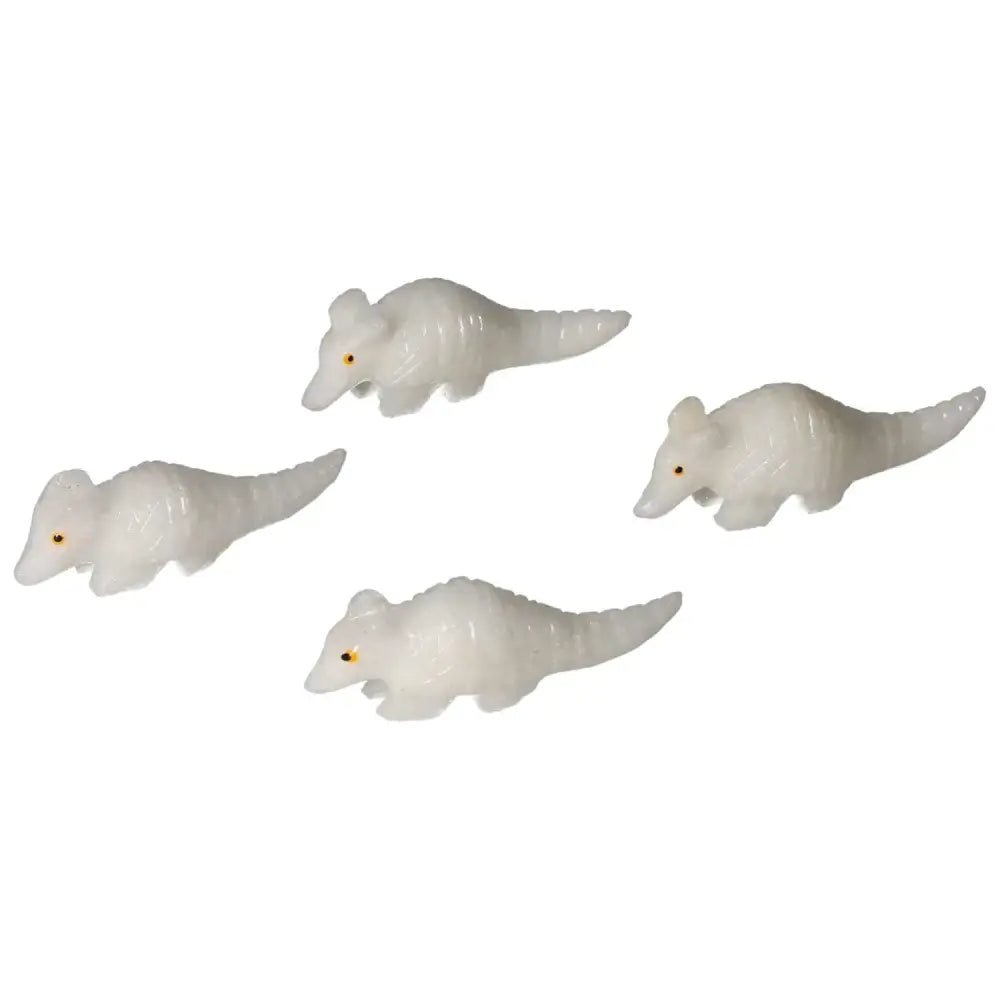 Four carved dolomite armadillos with detailed features, designed to embody calming properties and artistic craftsmanship.