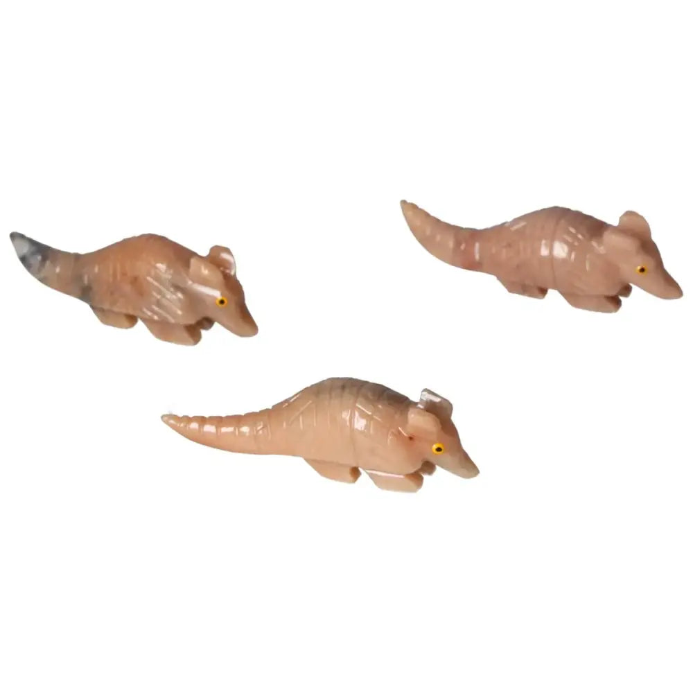 Three carved dolomite armadillos displayed on a white background, showcasing intricate craftsmanship and natural elegance.