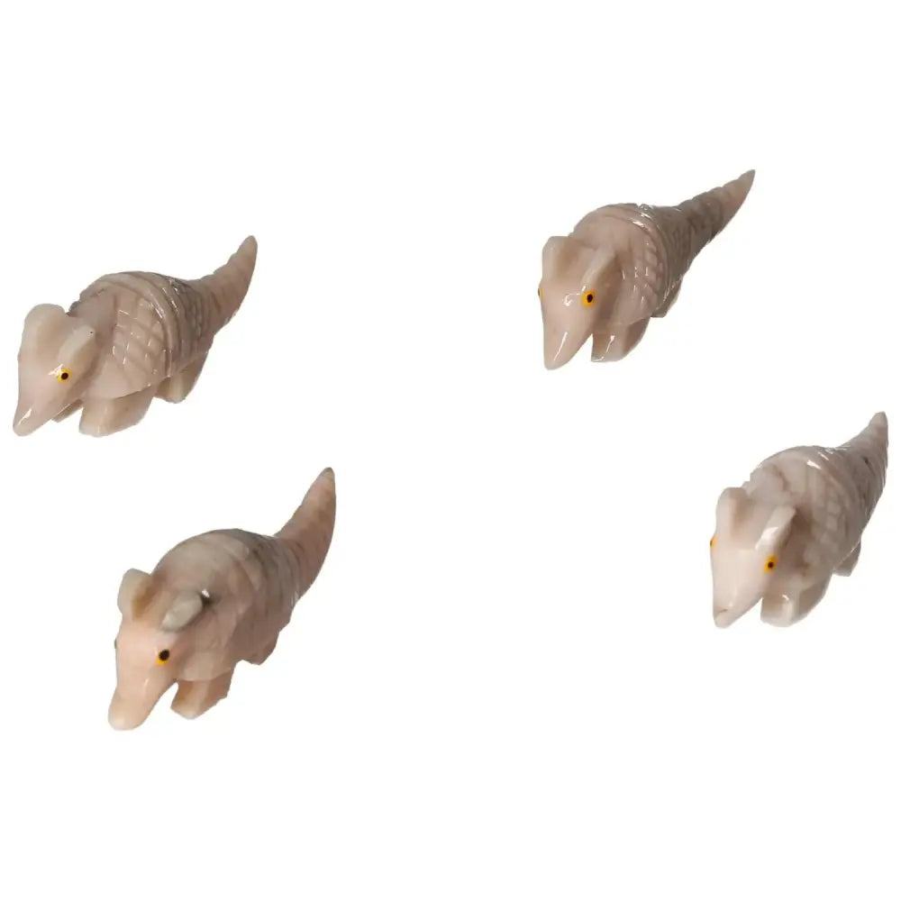 Four carved dolomite armadillo figurines, symbolizing tranquility and elegance, perfect for enhancing a serene atmosphere.