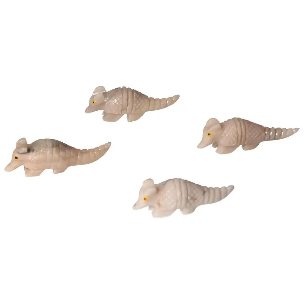 Four carved dolomite armadillos displaying craftsmanship and tranquility, premium pieces from Sylvia Crystals for aesthetic harmony.