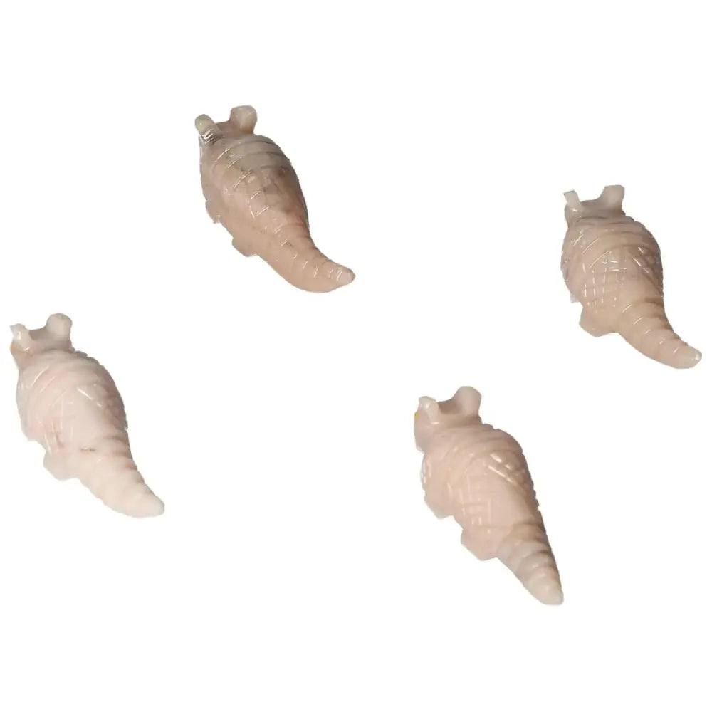 Four carved dolomite armadillos from Sylvia Crystals, symbolizing tranquility and aesthetic harmony, displayed on a white background.