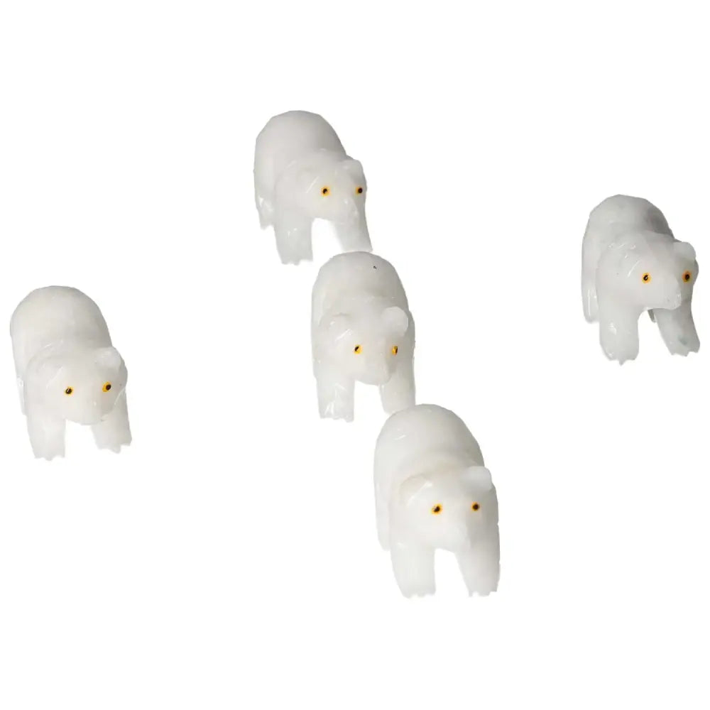 Four white carved dolomite bears in a line, showcasing premium design by Sylvia Crystals, for decor and emotional well-being.