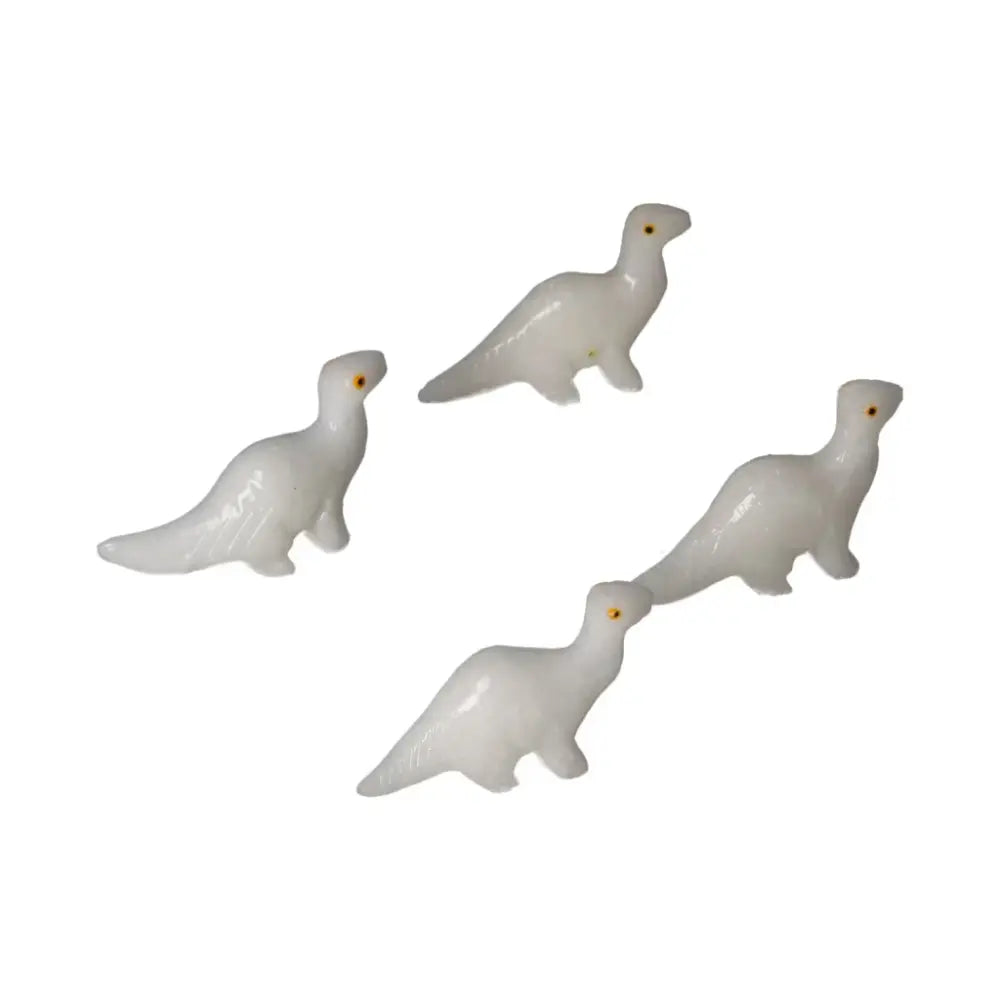 Carved Dolomite Dinosaur figurines by Sylvia Crystals, showcasing natural artistry and emotional grounding properties.
