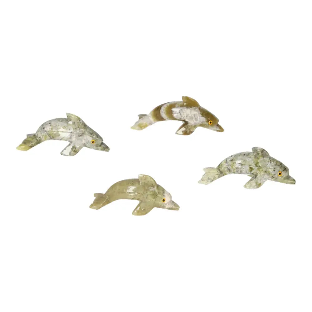Four carved dolomite dolphin figurines from Sylvia Crystals, showcasing unique grounding energy, perfect for enhancing decor and emotional calm.