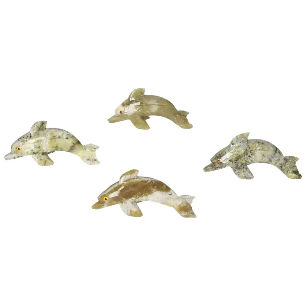 Four carved dolomite dolphins showcasing unique natural hues, crafted by Sylvia Crystals, known for their grounding metaphysical properties.