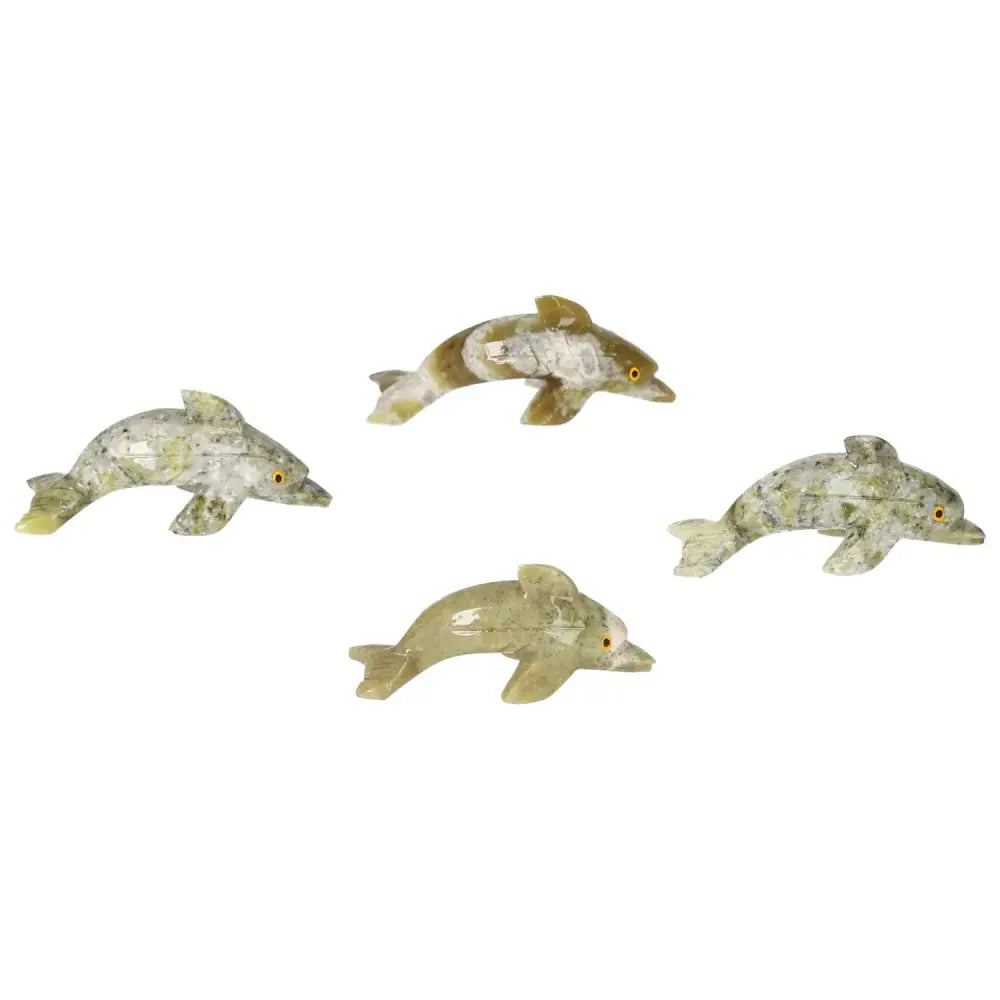 Four carved dolomite dolphin figurines from Sylvia Crystals, showcasing intricate craftsmanship and metaphysical properties for calmness.