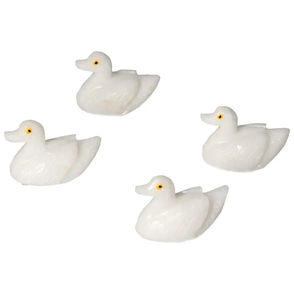 Four carved dolomite duck figurines from Sylvia Crystals, enhance emotional balance with natural grounding properties.