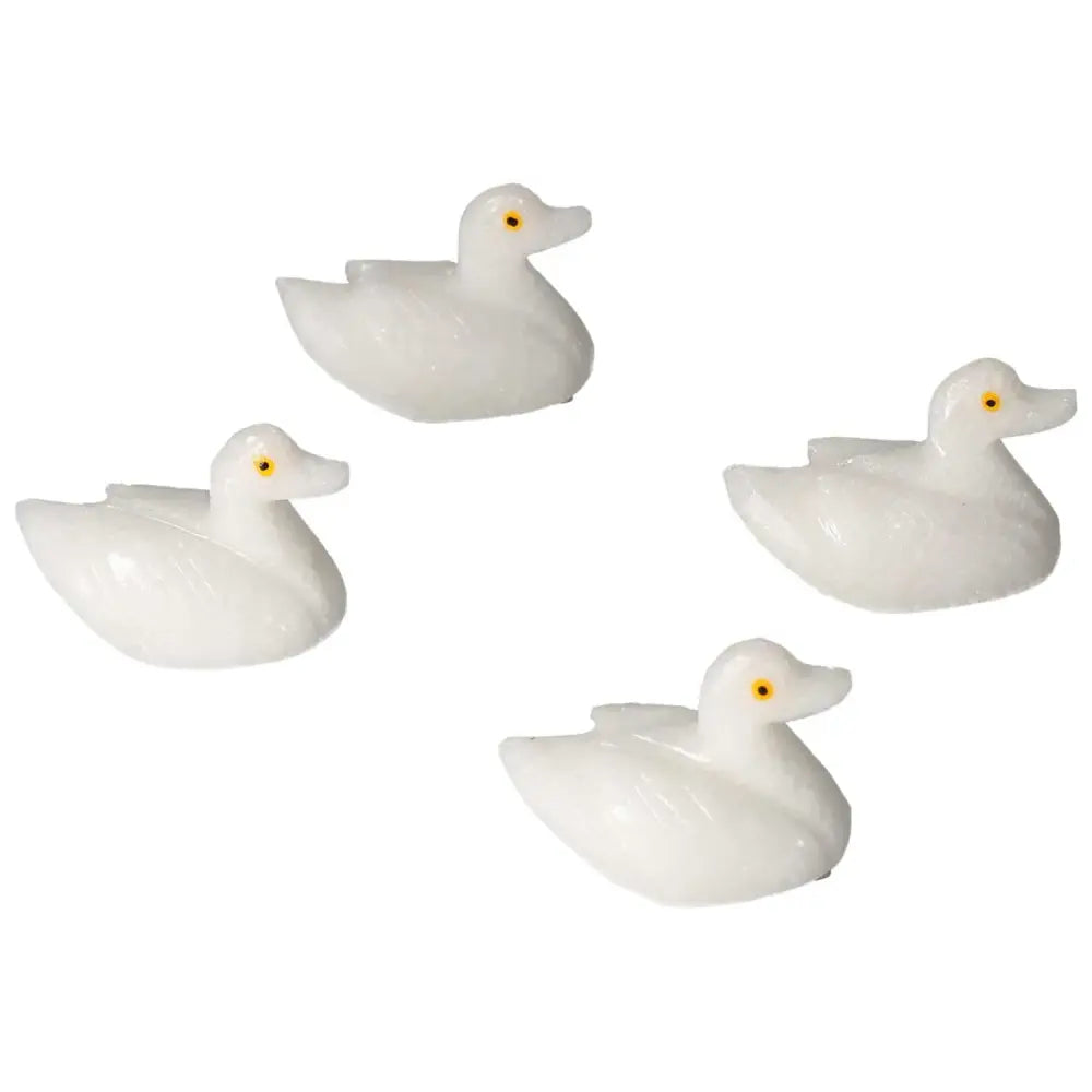 Four carved dolomite duck figurines by Sylvia Crystals, promoting calm and emotional balance, ideal for decor and meditation.