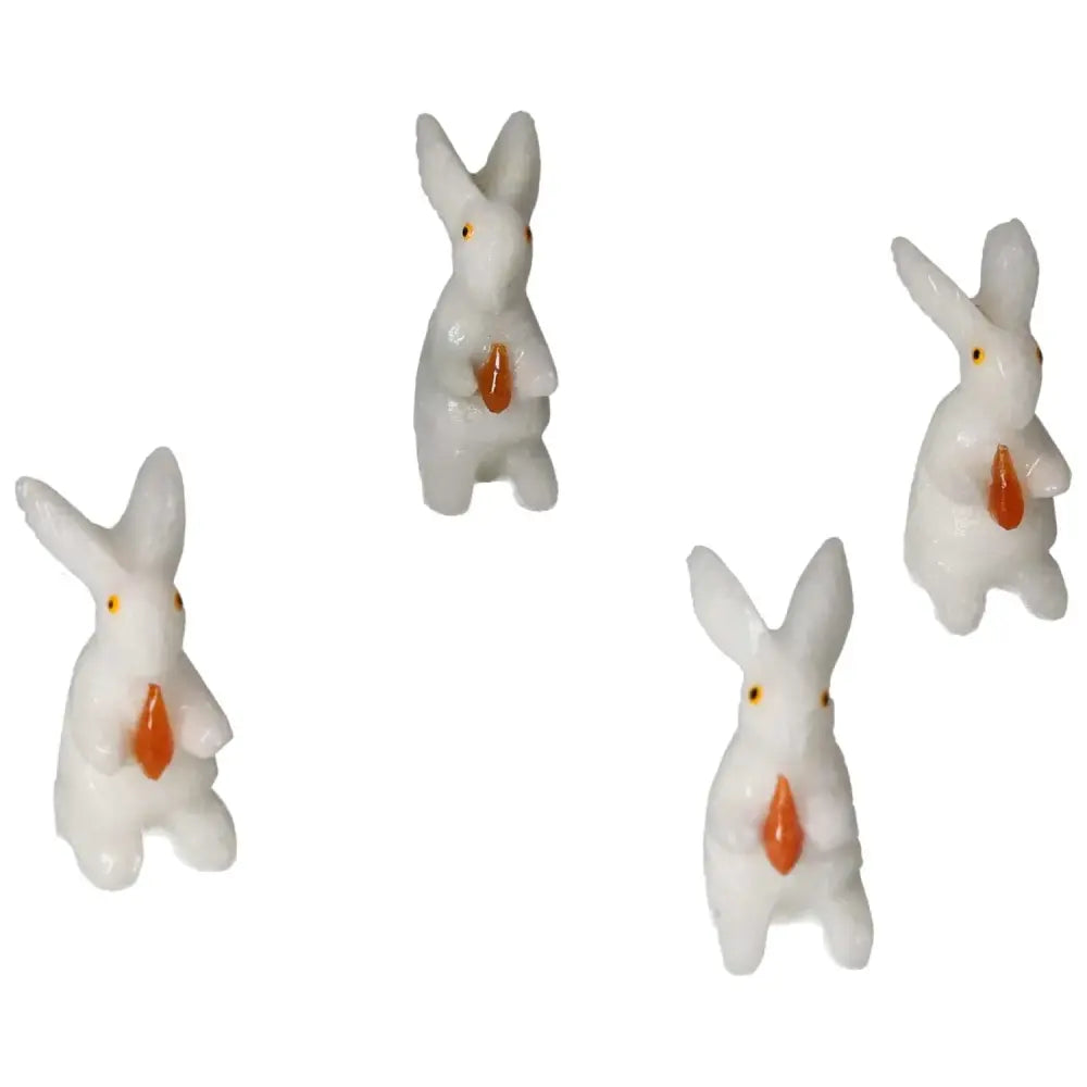 Four carved dolomite rabbit figures from Sylvia Crystals, promoting emotional balance and luxury decor for home or office.