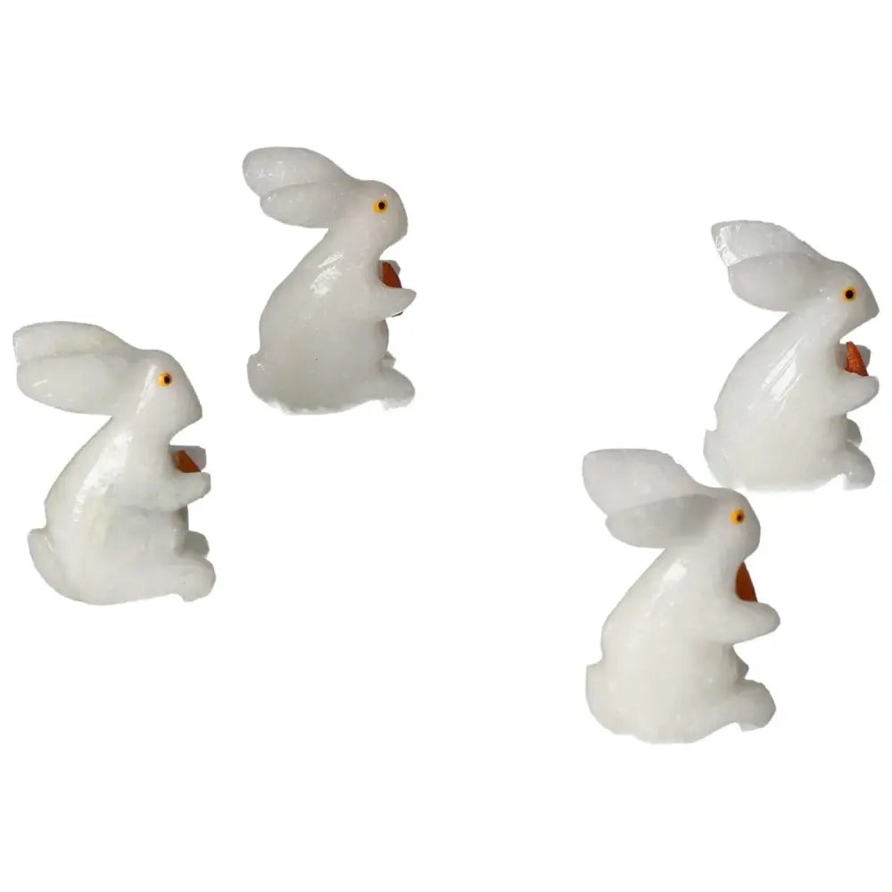 Four carved dolomite rabbits from Sylvia Crystals, promoting emotional well-being and spiritual balance in home decor.