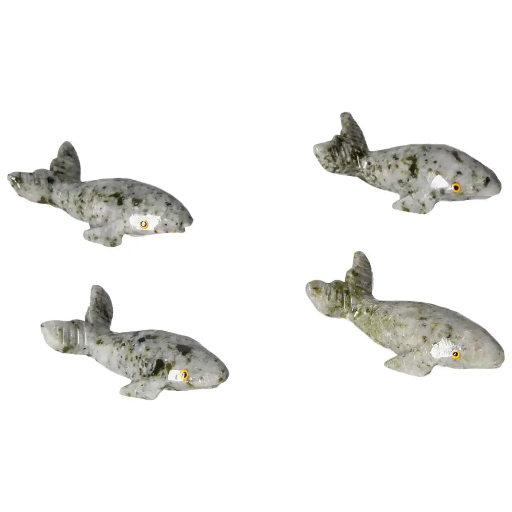 Four carved dolomite whales, showcasing unique textures and grounding properties, perfect for home decor and tranquility from Sylvia Crystals.
