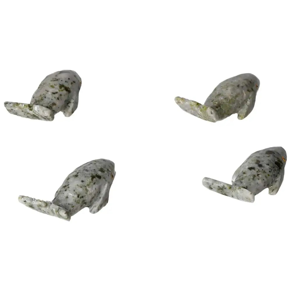 Carved dolomite whale sculptures showcasing natural texture and calming properties, symbolizing peace and tranquility.