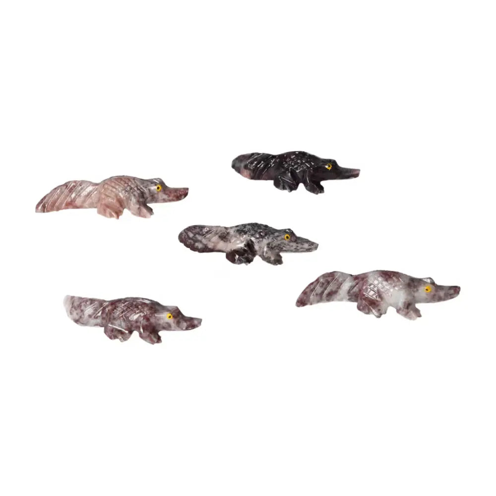 Assorted carved magnesite alligator figures showcasing detailed craftsmanship from Sylvia Crystals, symbolizing strength and calmness.