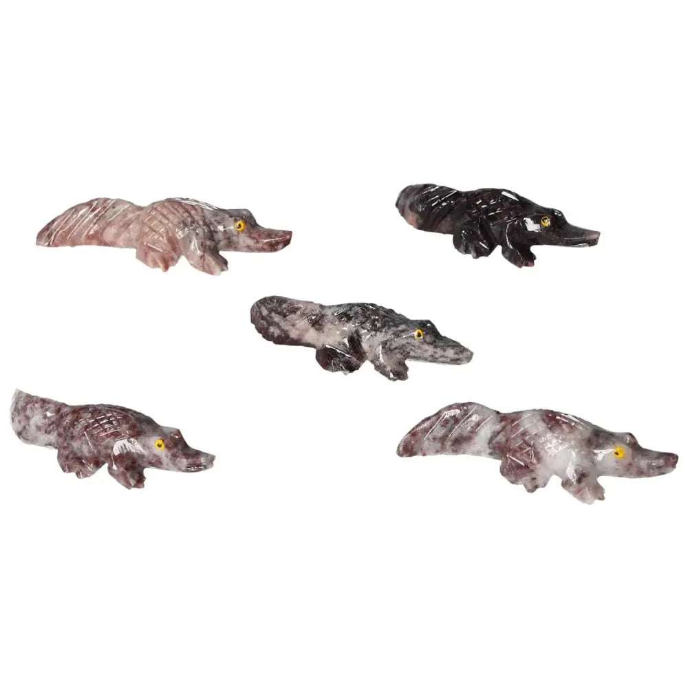Carved magnesite alligator sculptures showcasing intricate craftsmanship and spiritual enrichment from Sylvia Crystals.