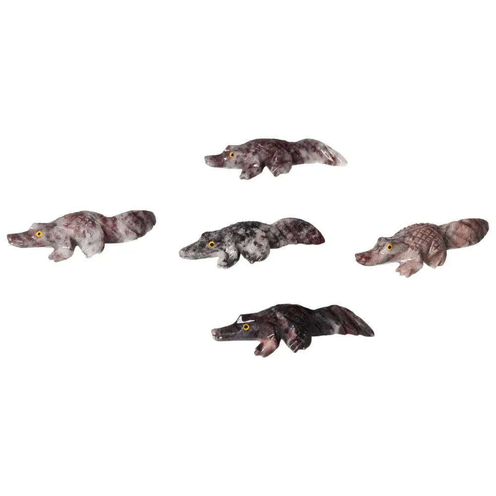 Carved magnesite alligator figurines from Sylvia Crystals, symbolizing strength and artistry with calming spiritual properties.