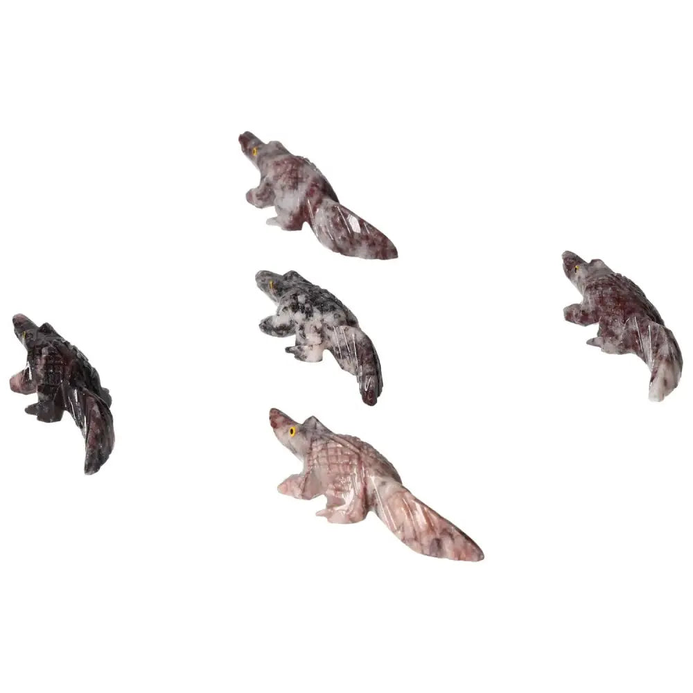 Collection of carved magnesite alligator figurines, showcasing artistry and calming properties from Sylvia Crystals.