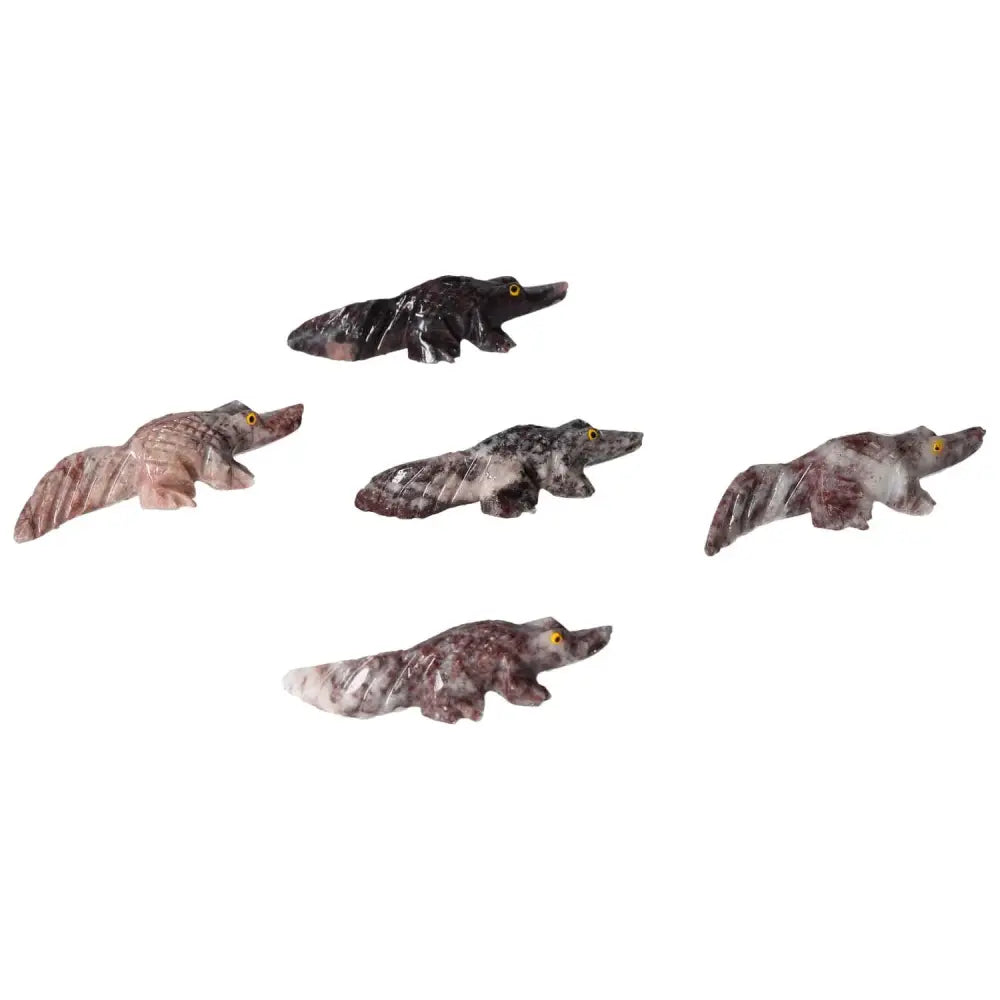 Five carved magnesite alligator figurines showcasing artistic craftsmanship, designed to symbolize strength and spiritual enrichment.