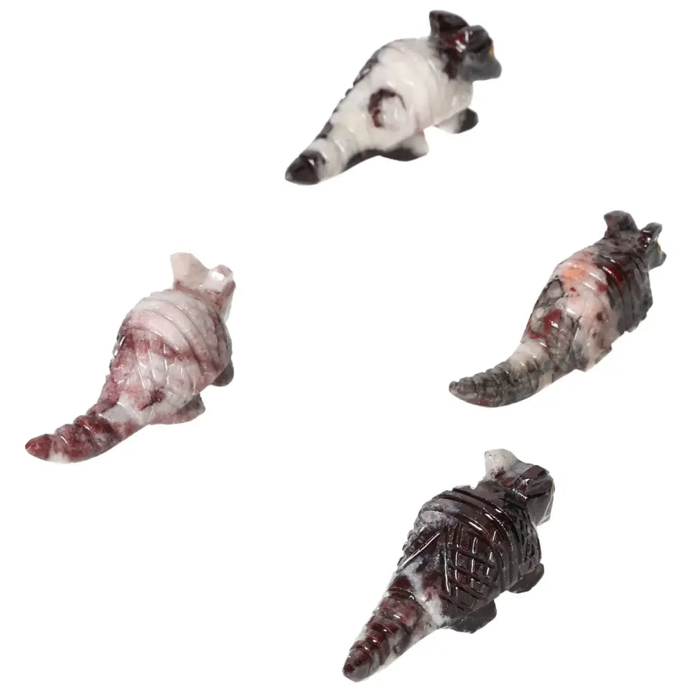 Four hand-carved magnesite armadillo figurines showcasing intricate detail and natural markings, enhancing spiritual and decorative spaces.