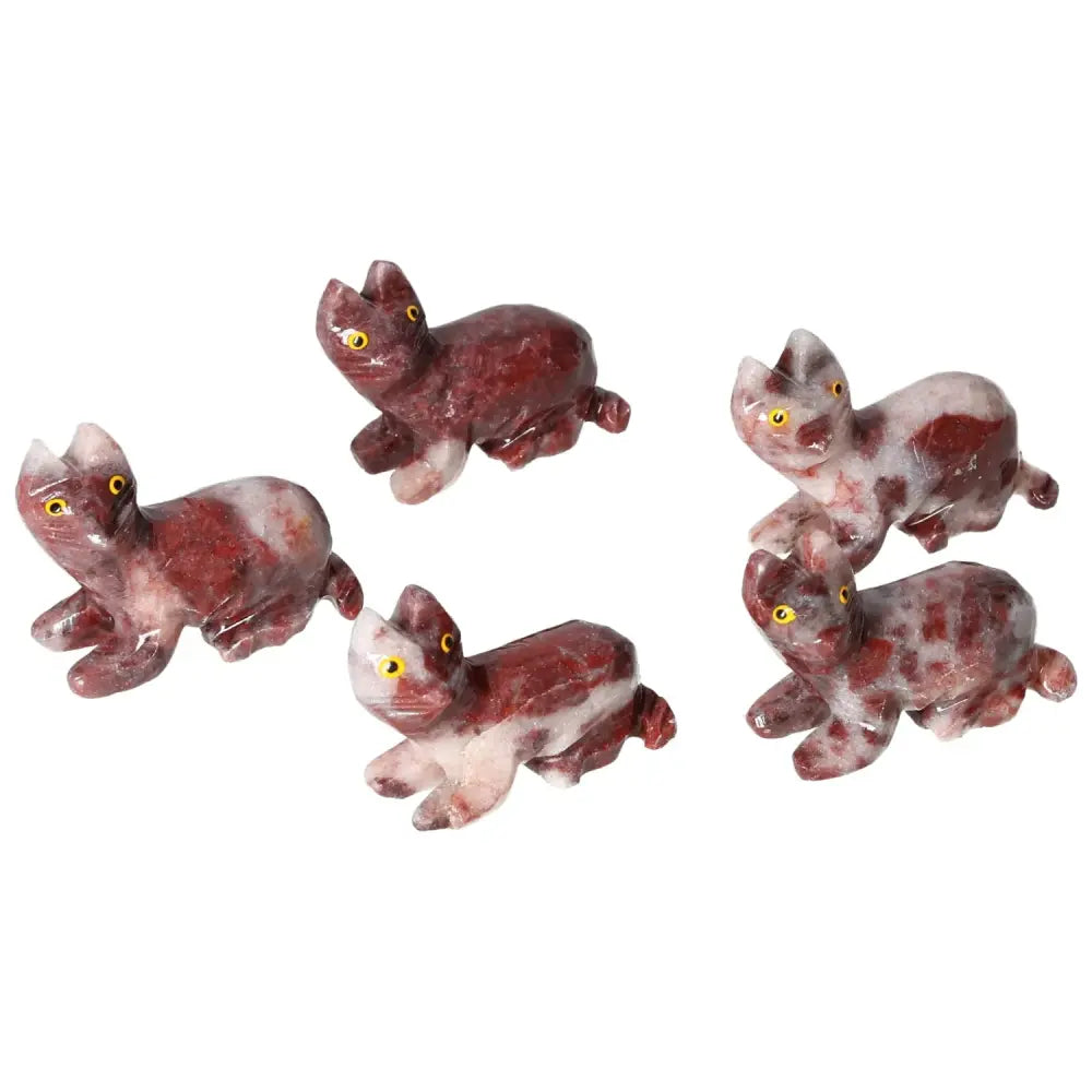 Group of intricately carved magnesite cat figurines showcasing detailed craftsmanship and red marbling, ideal for decor and meditation.