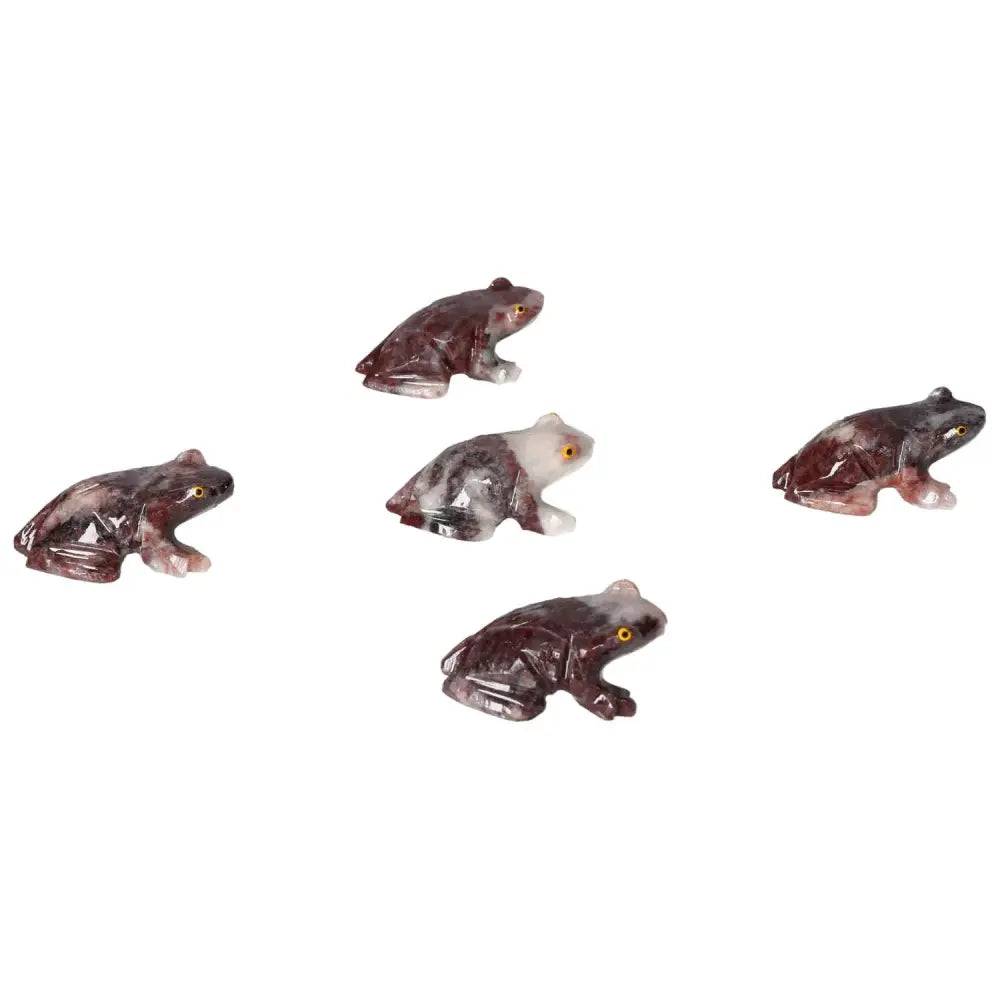 Five carved magnesite frogs showcasing detailed craftsmanship and natural stone variations, embodying spiritual and calming properties.