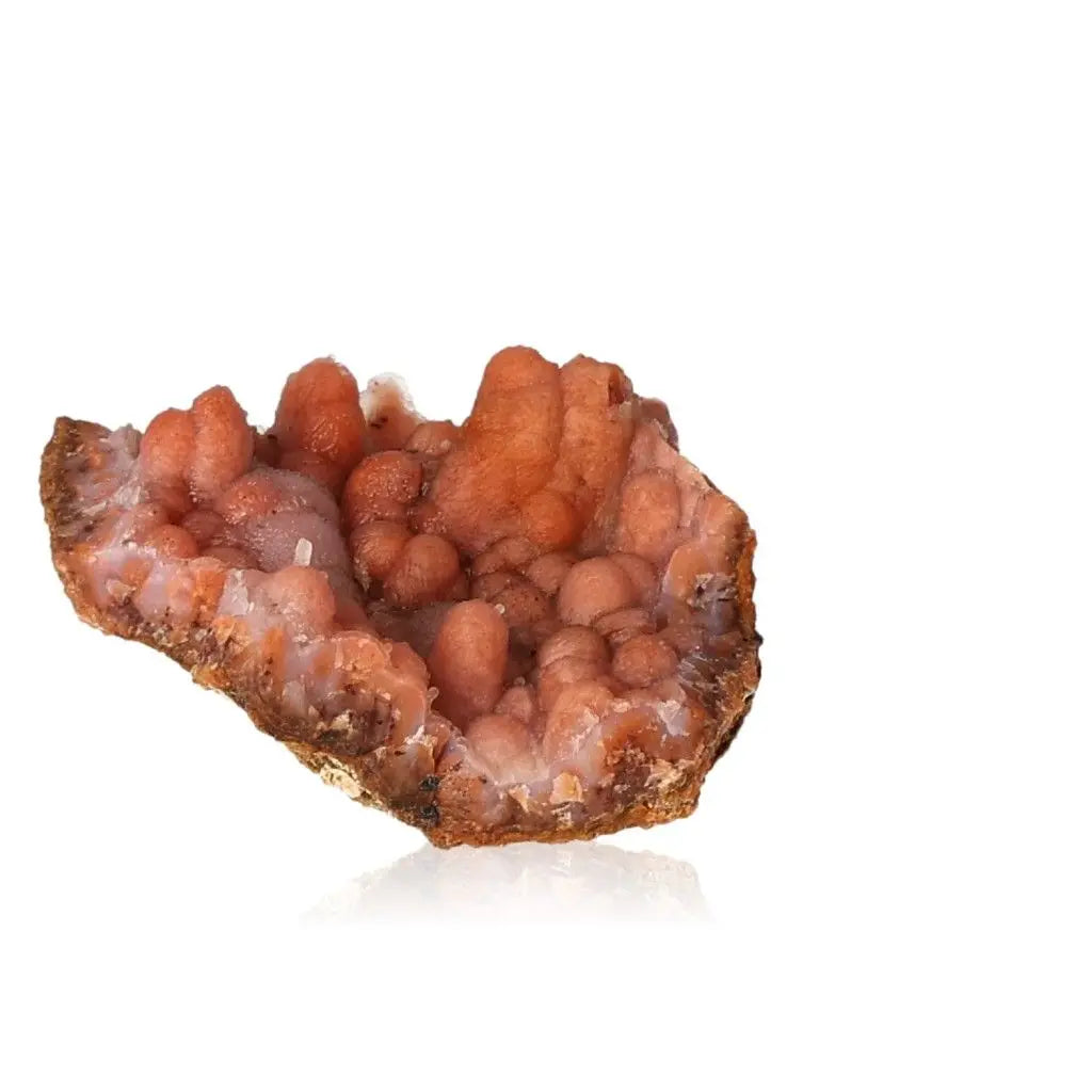Close-up of an orange Chalcedony Stalactite crystal, featuring intricate textures and natural formations.