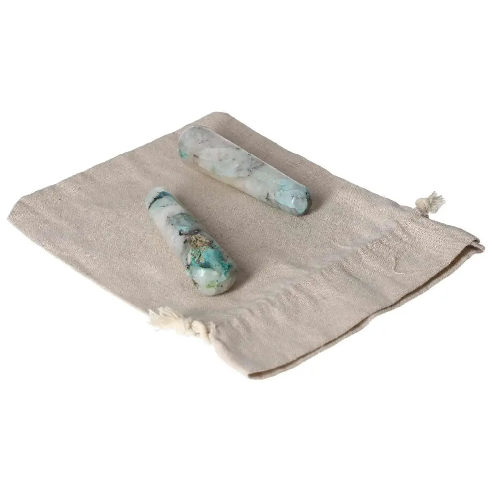 Chrysocolla wands on a beige cloth, showcasing powerful feminine energy and aiding in speech and emotional understanding.