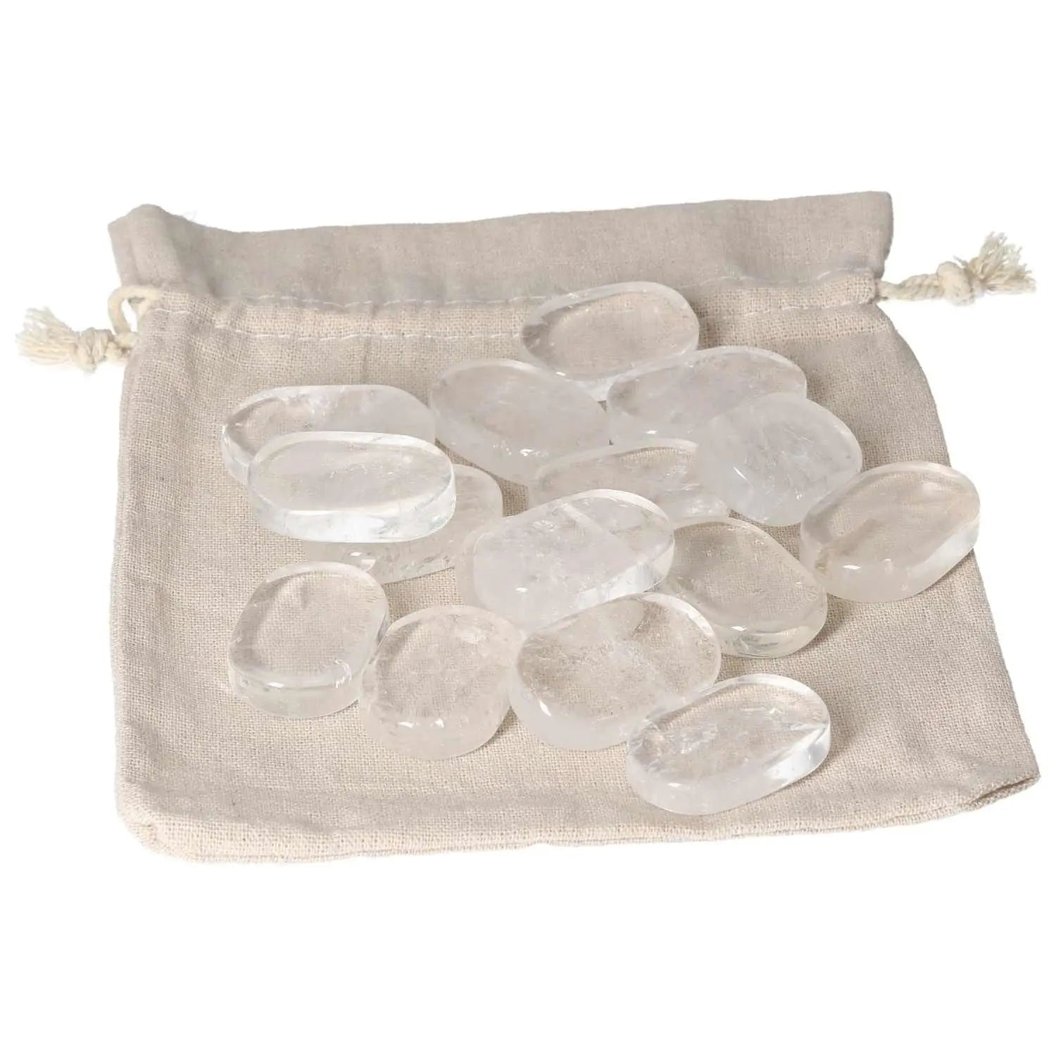Clear quartz thumb massagers on a beige bag, offering stress relief and balance for daily wellness routines.